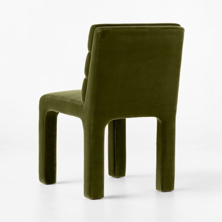 a green chair sitting on top of a white floor