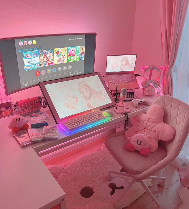 a desk with a laptop, computer monitor and stuffed animals on it in a pink room