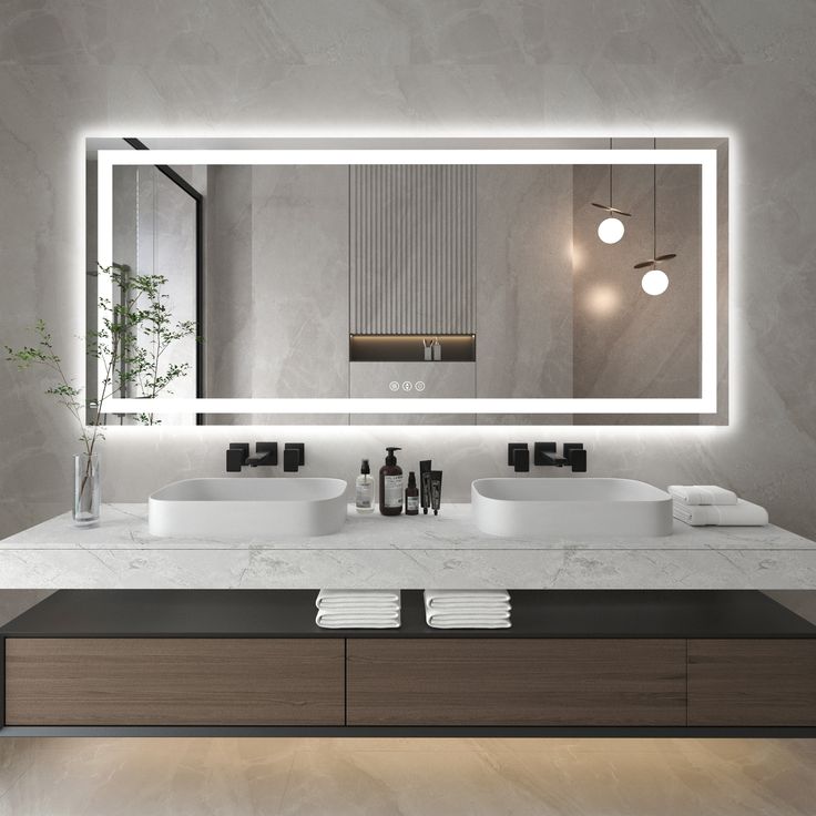 a modern bathroom with two sinks and a large mirror above the sink is illuminated by lights