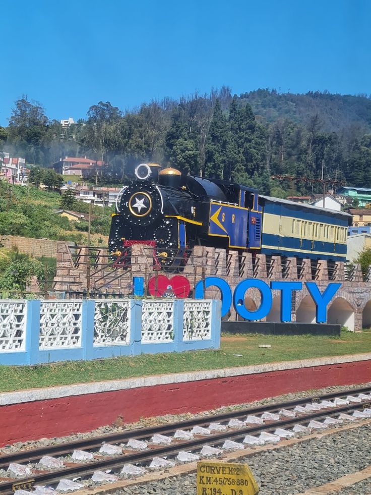 a train is on display in front of a sign with the word victory painted on it