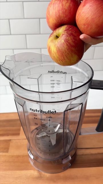 two apples are being weighed in a blender