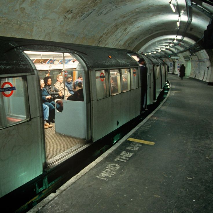 people are sitting on the subway train in the station and waiting for their next ride