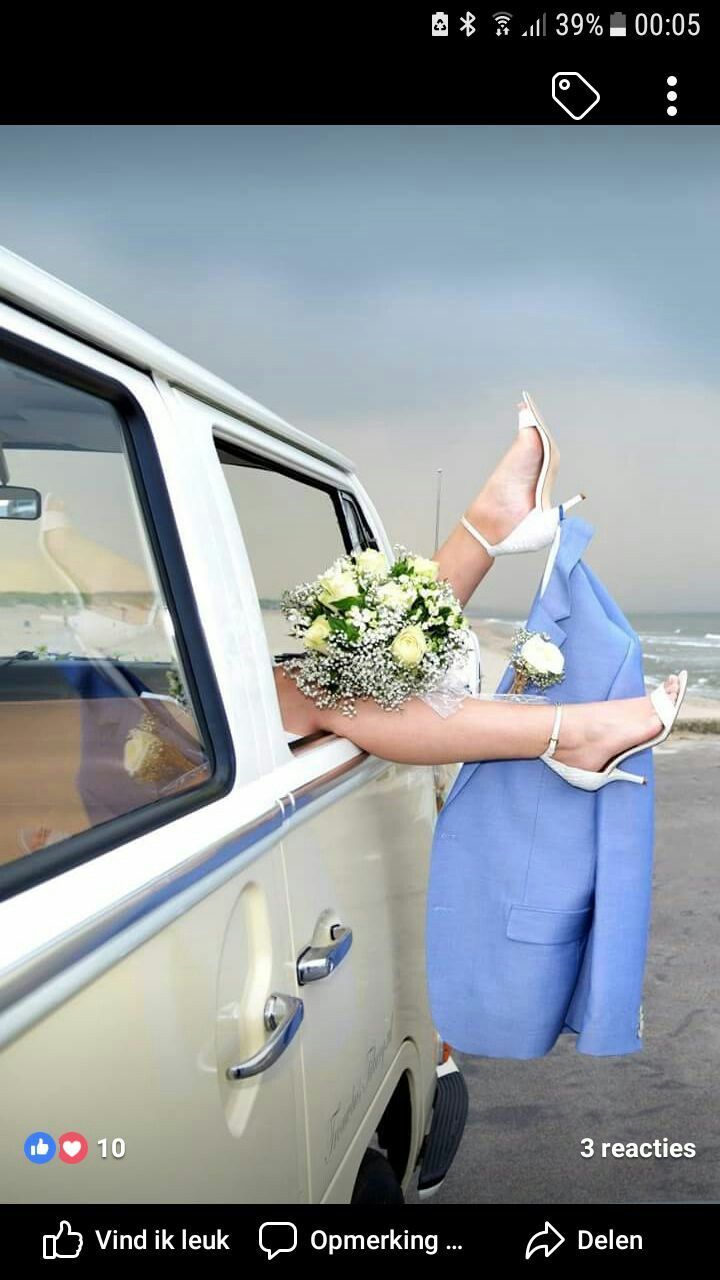 a woman in a blue dress leaning out the window of a white truck with flowers