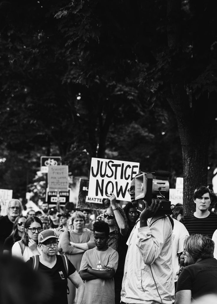 black and white photograph of people holding signs