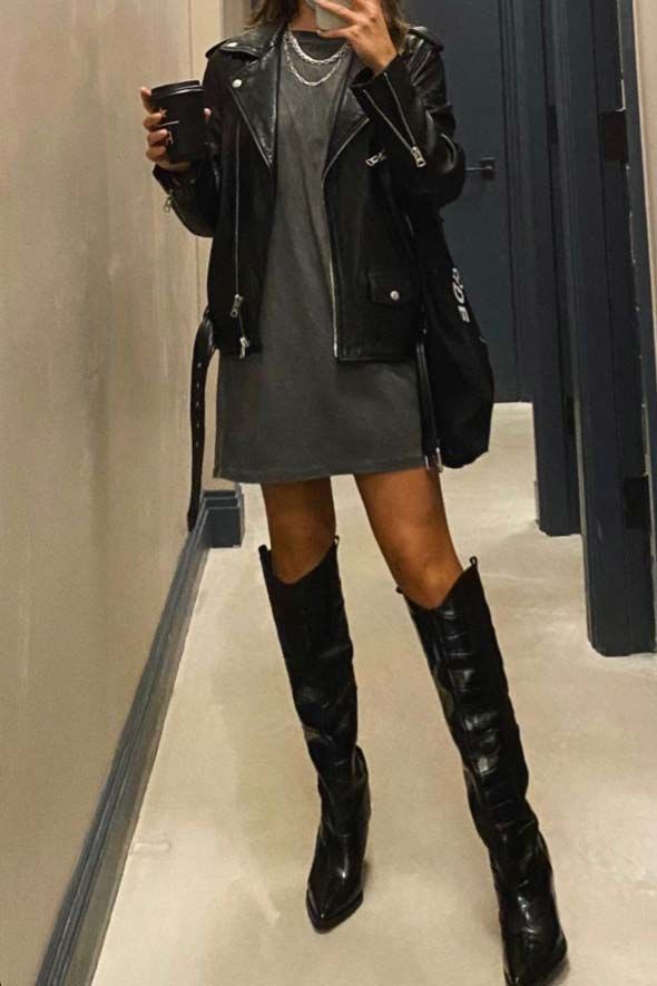 A woman taking a selfie in the mirror, wearing leather knee-high black cowboy boots styled with a leather jacket. Cow Boy Boots Outfit For Women Winter, Cowboy Boot Outfits Going Out, Cowboy Boots Outfit 2024, Black Knee High Cowboy Boots Outfit, Black Cowgirl Boots Outfit Winter, Black Cowboy Boot Outfits, Tall Black Cowboy Boots Outfit, Cowboy Boot Outfits Winter, Bongos Bingo