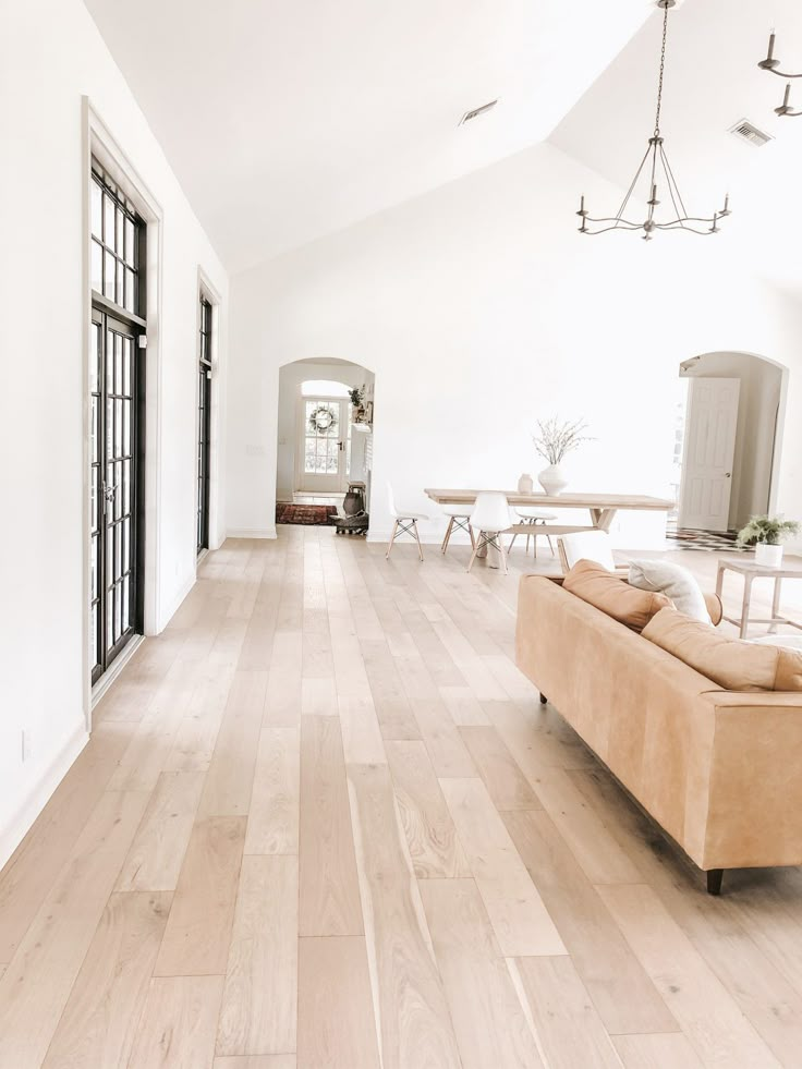 a living room with hard wood floors and white walls