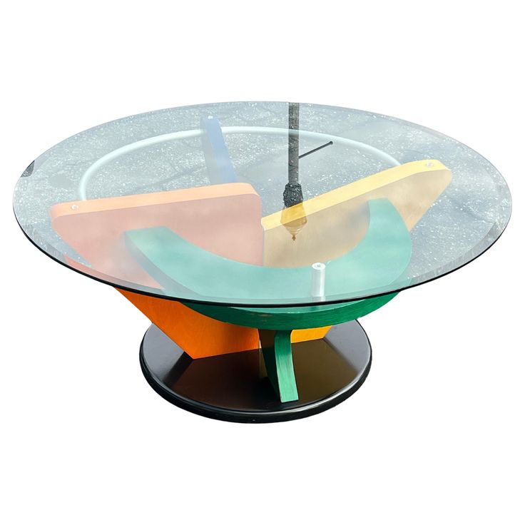 a glass table with different shapes and colors on the top, sitting in front of a white background