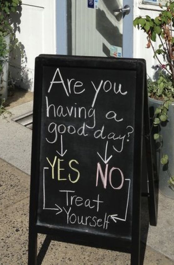 a chalkboard sign that says are you having a good day? yes no treat yourself