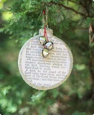 a christmas ornament hanging from a tree with two bells on it's side