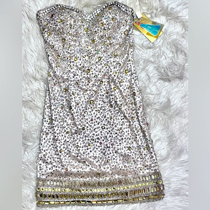 Nwt Lara Design Stunning Strapless Dress. Size 2, Kept Very Meticulously. Covered In Gorgeous Beading, Nude Base Color With Silver And Gold Beads (See Photos). Offers Accepted. Metallic Embellished Sleeveless Mini Dress, Sleeveless Embellished Metallic Mini Dress, Embellished Sleeveless Metallic Mini Dress, Metallic Embellished Sleeveless Dress, Silver Sleeveless Sequin Dress With Rhinestones, Glamorous Festive Dress With Rhinestones, Metallic Strapless Sequin Dress, Metallic Strapless Dress With Sequins, Silver Bedazzled Dress For Gala