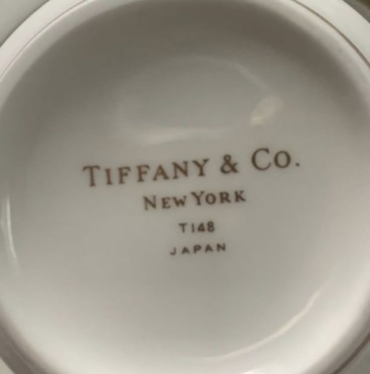 a white porcelain plate with the words tiffany & co new york and japan on it