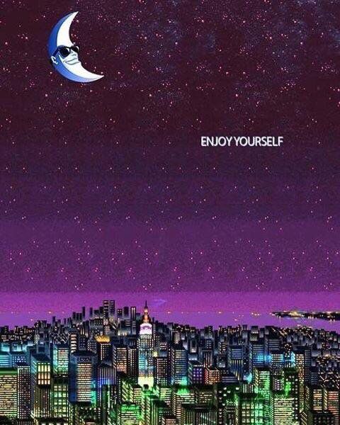 an image of a city at night with the words enjoy yourself written in front of it