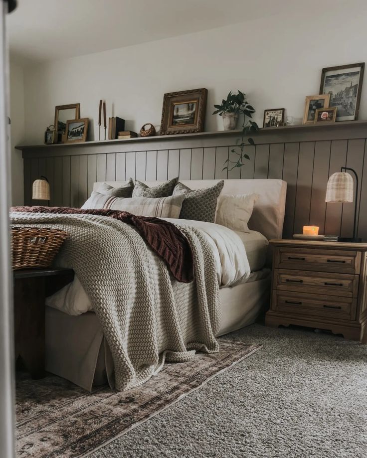 a bedroom with a bed, nightstands and pictures on the wall