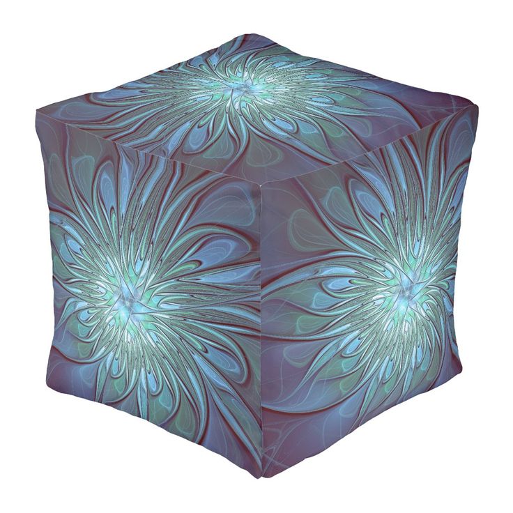 an abstract blue and green flower design on a square cube shaped object with swirly petals