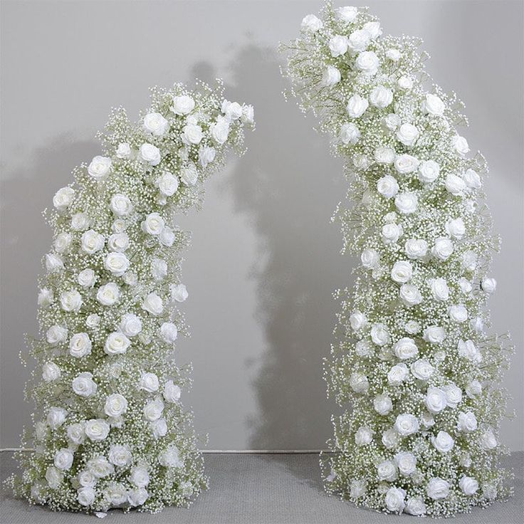 two vases with white flowers on them