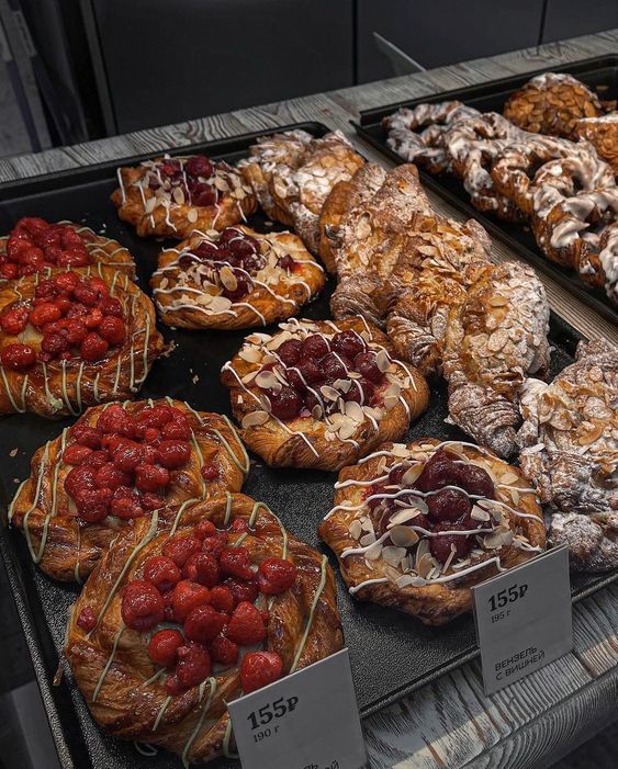 various pastries are on display in a bakery