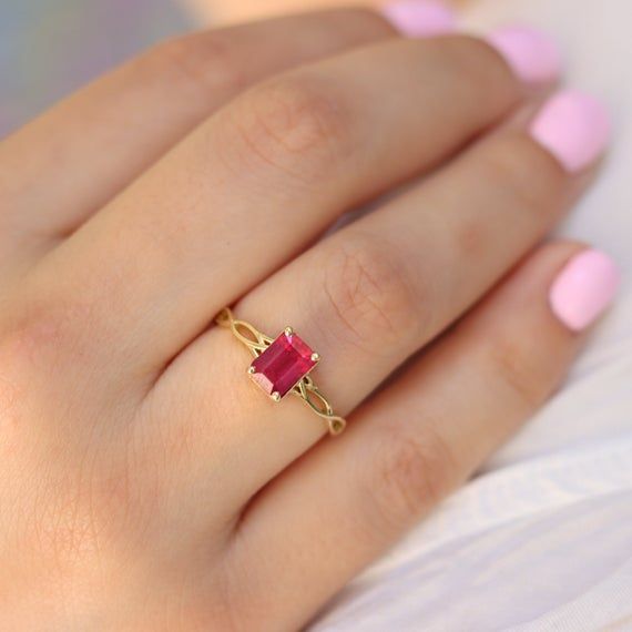 This vintage inspired ring is set with a beautiful pink Ruby to make you feel like a princessA dainty and unique Celtic pattern to encircle your finger. Handmade by an inspired jewelry artist team with decades of experience in the craft of jewelry making.Each gemstone, each diamond is carefully picked.Using only the finest raw materials and the highest industry standard in manufacturing, design and finish.Set with a 7x5 Octagon cut Pink Ruby 1.06 ctAll ring sizes available, if you cannot find yo Delicate Emerald Cut Promise Ring, Dainty 14k Gold Emerald Cut Birthstone Ring, Dainty Emerald Cut Gemstone Ring, Dainty 14k Gold Birthstone Ring With Emerald Cut, Dainty Emerald-cut Birthstone Ring, Delicate 14k Gold Pink Ring, Dainty Princess Cut Yellow Gold Jewelry, Dainty Emerald Cut Birthstone Ring, Dainty Yellow Gold Princess Cut Jewelry