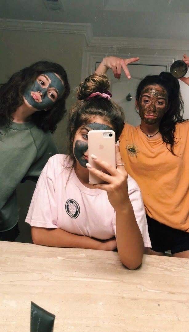 three people with face paint taking a selfie