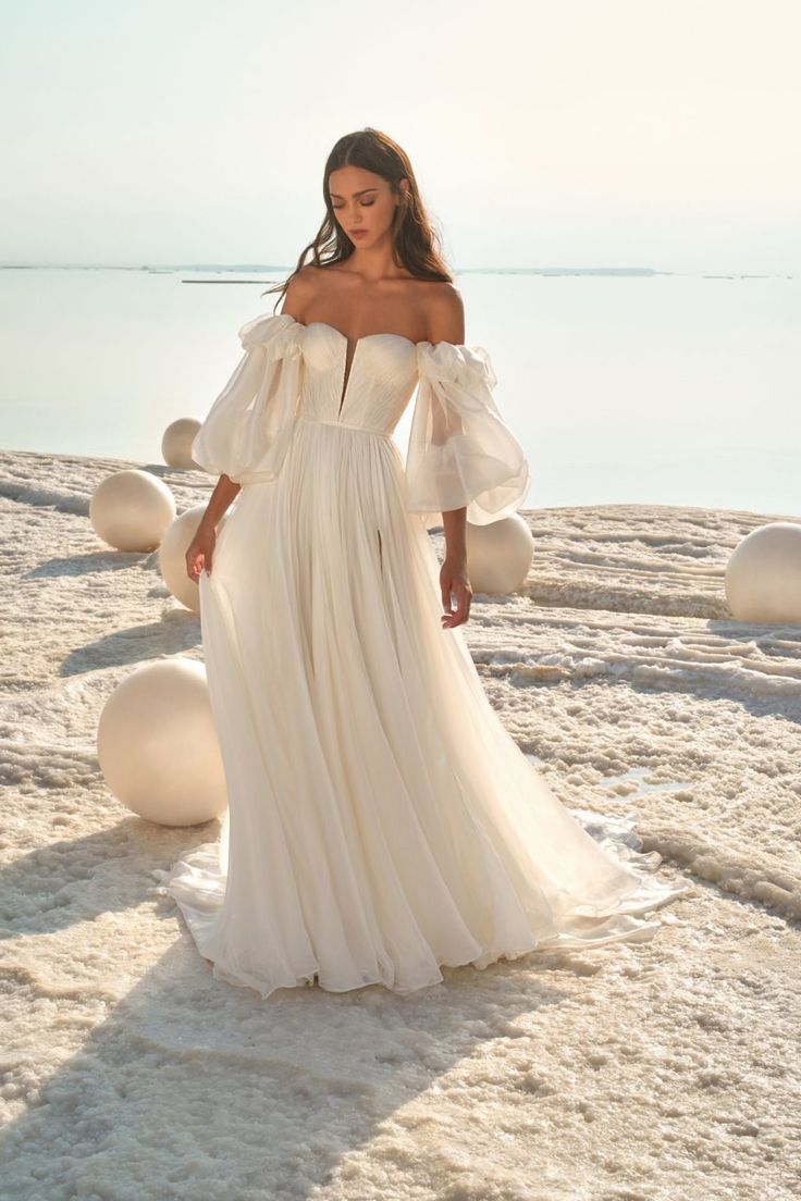 a woman in a white dress on the beach