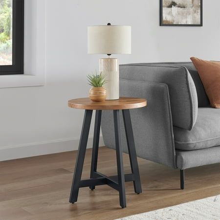 a living room with a gray couch and wooden table in it's centerpiece