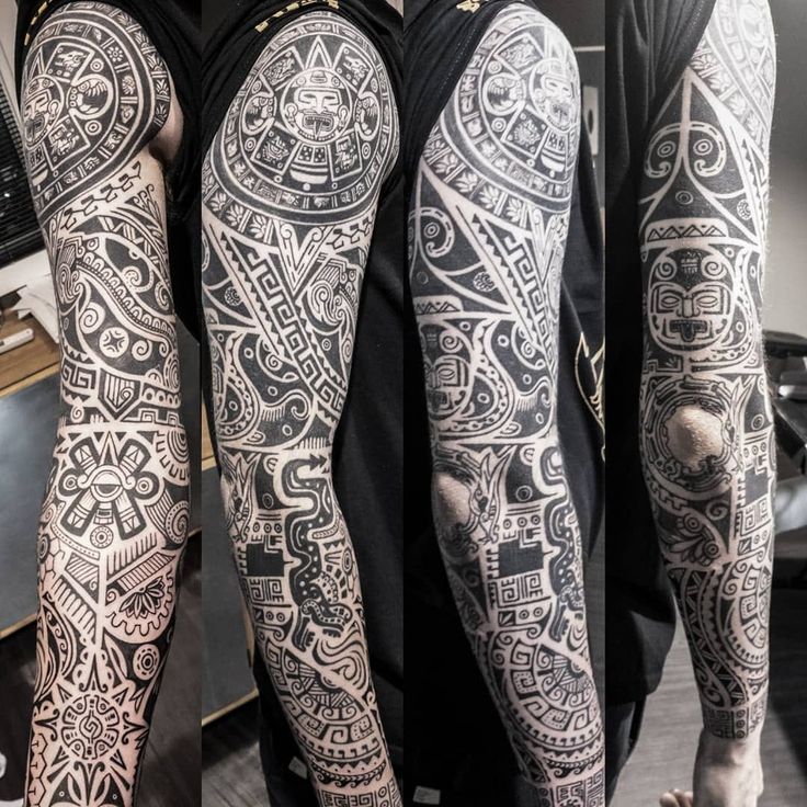 two men with tattoos on their arms