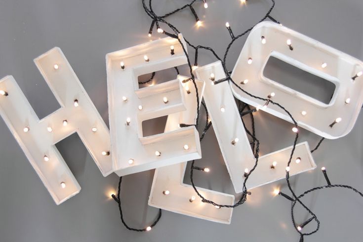 the letters h and f are decorated with fairy lights, which hang from string lights