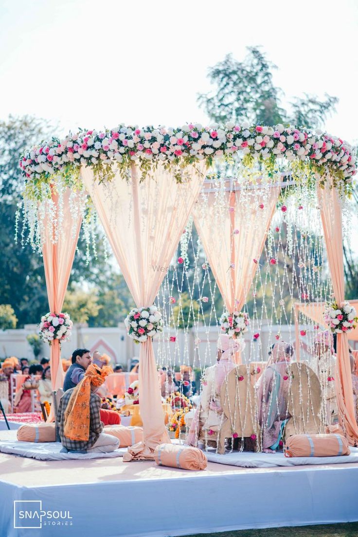 an outdoor wedding setup with flowers and decorations