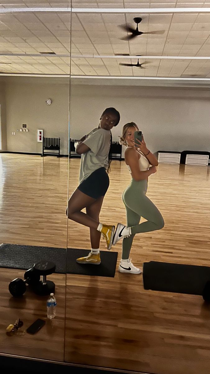 two people in a dance studio with mirrors