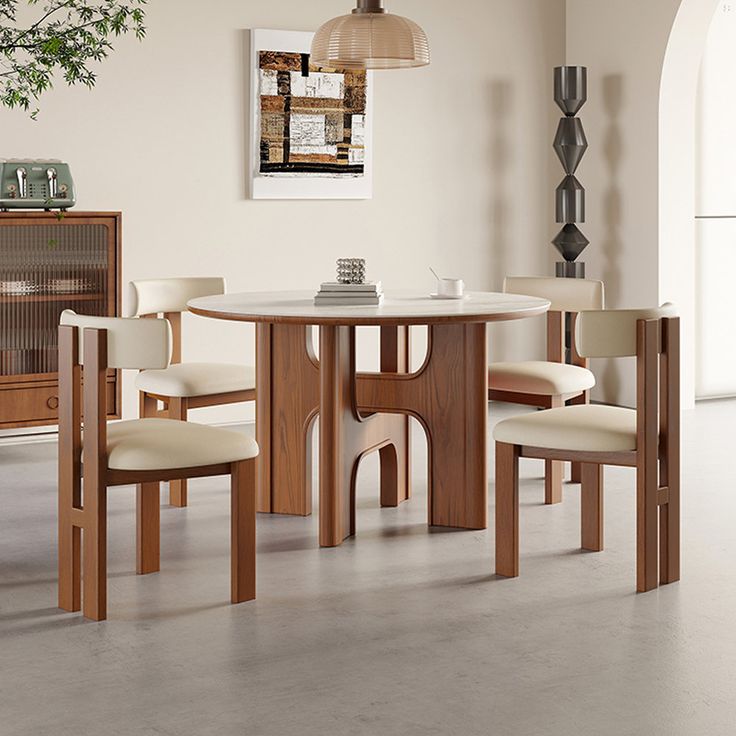 a dining room table with four chairs around it