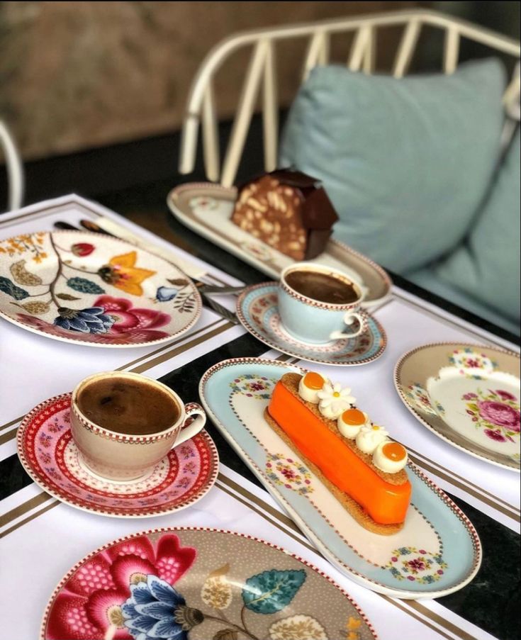 there are plates with desserts on them sitting on the table next to each other