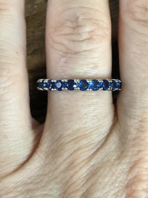 A simple and elegant royal blue sapphire (natural) full eternity ring.    The original ring was from a small estate sale in Chelsea, London, and was stunning.  We decided to recreate the exact ring and make it available again.  It is a classic 2mm stacking full eternity ring.  Perfect for that September birthday also.  Natural Round Cut Royal Blue Sapphires (heated)925 Sterling Silver/RhodiumGift Box Formal Blue Sapphire Eternity Band, Blue Round Eternity Band For Anniversary, Blue Eternity Band For Promise, Elegant Blue Eternity Band, Blue Round Eternity Band With Prong Setting, Blue Sapphire Eternity Band For Promise Ring, Blue Half Eternity Band With Round Cut, Elegant Sapphire Eternity Band With Prong Setting, Elegant Sapphire Stackable Eternity Band