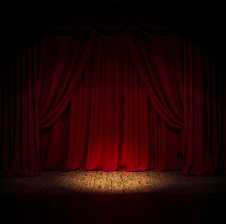 a red curtain with light shining through it