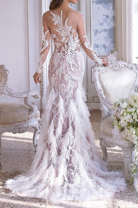 a woman in a wedding dress standing next to a chair