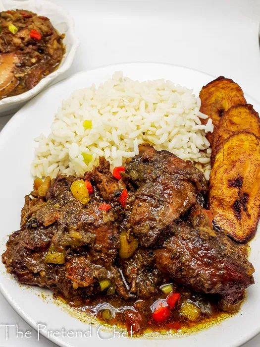 two white plates filled with meat and rice