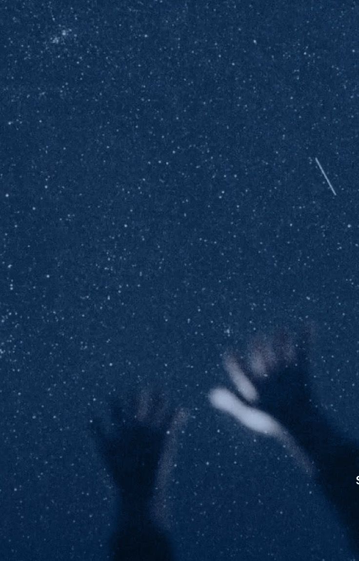 two hands reaching up into the sky with stars in the background and an airplane flying overhead