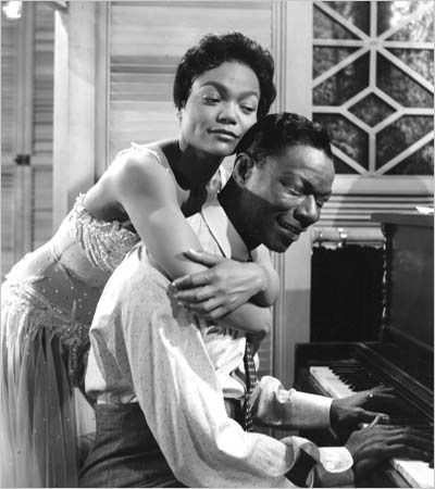 two men are playing the piano together