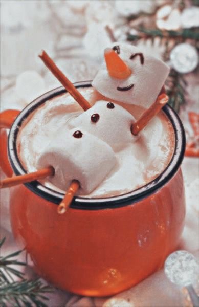 two marshmallows in a mug with snowmen on top