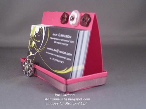 a business card holder made out of pink cardboard with buttons on the front and sides