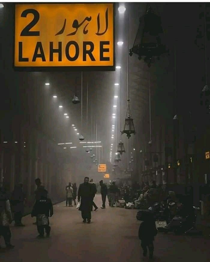 people are walking down the street in front of a sign that reads 2 lahore