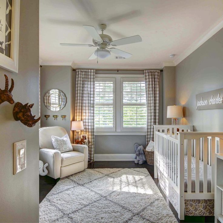 a baby's room with a white crib and gray walls