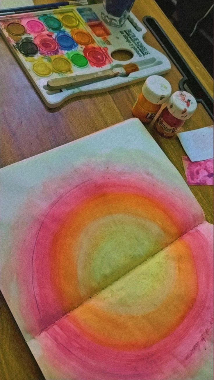 an art project with watercolors and paints on the table