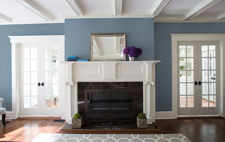 a living room filled with furniture and a fire place in the middle of a room