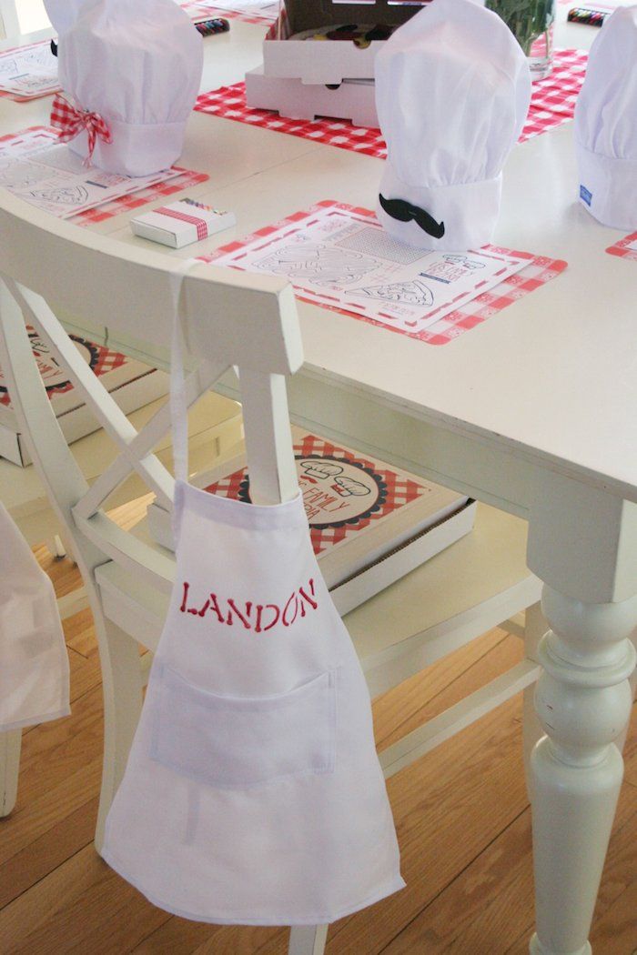 the aprons are hanging from the table