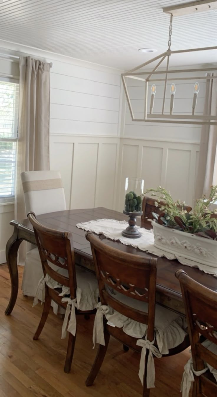 the dining room table is set with chairs and place settings for four people to sit at