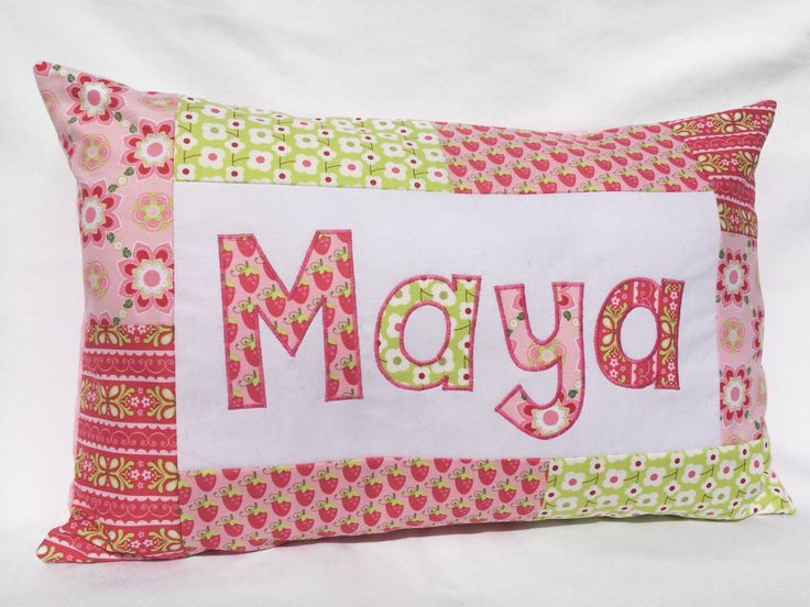 a decorative pillow with the word mayo on it's front and back, in bright colors