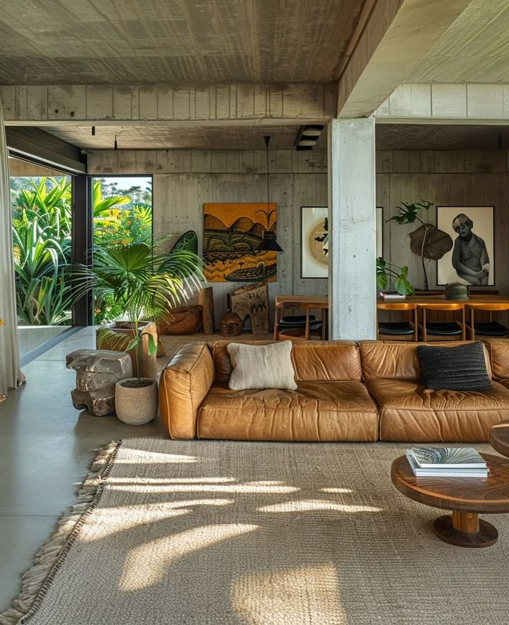 a living room filled with lots of furniture and plants on top of carpeted flooring