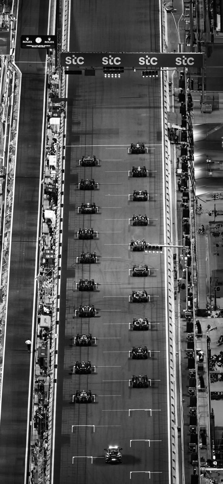 black and white photograph of an aerial view of race cars