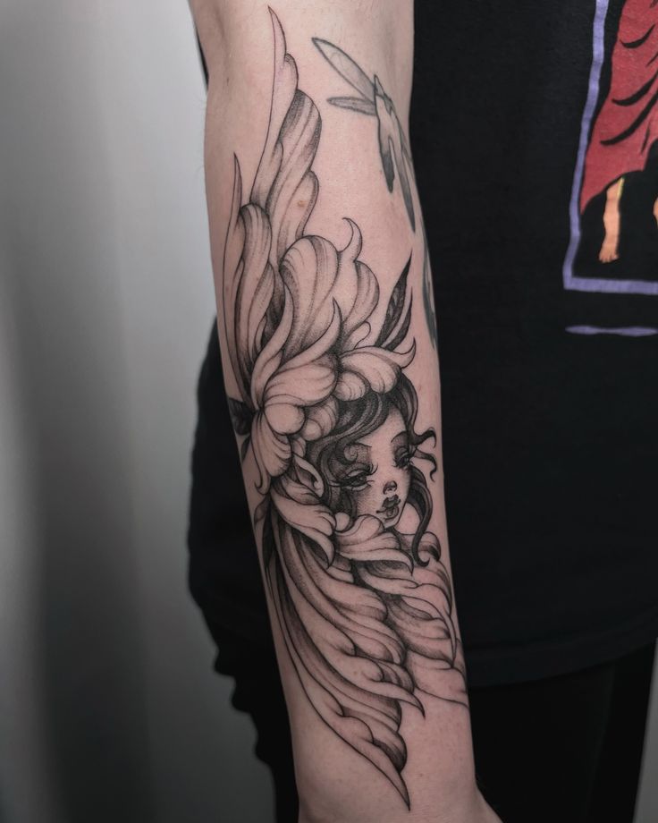 a woman's arm with a flower tattoo on the left side of her body