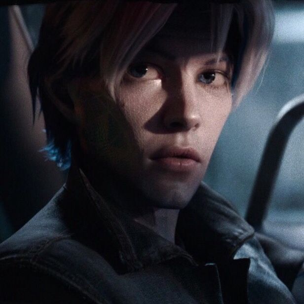 a young man with blonde hair sitting in a car