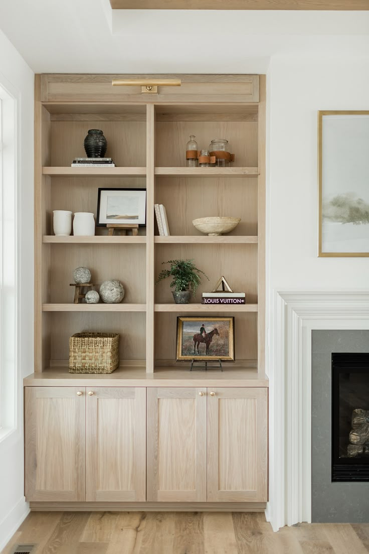 a living room with a fireplace and bookcases